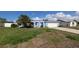 Charming home exterior featuring a blue façade, white trim, and well-maintained front yard at 249 Malvern Dr, Venice, FL 34293