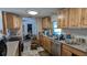 The kitchen features wood cabinets and leads to the dining room at 249 Malvern Dr, Venice, FL 34293