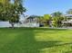 Beautiful backyard with lush green grass and waterfront access featuring a covered boat lift at 4713 9Th E St, Ellenton, FL 34222