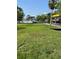 Expansive backyard with lush green lawn and dock with a gazebo sitting on the water, perfect for enjoying waterfront living at 4713 9Th E St, Ellenton, FL 34222