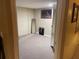 This carpeted basement area features neutral walls and a large mirror; a versatile space for storage or a home gym at 4713 9Th E St, Ellenton, FL 34222