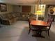 Basement featuring a comfortable sectional sofa, small dining table, and paneled ceiling with lights at 4713 9Th E St, Ellenton, FL 34222