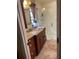 Bathroom featuring updated vanity with granite countertop and tiled walk-in shower at 4713 9Th E St, Ellenton, FL 34222