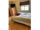 Bedroom with neutral walls and hardwood floors, complemented by natural lighting at 4713 9Th E St, Ellenton, FL 34222