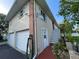 Two-story home featuring a two-car garage, exterior staircase, and brick accent wall at 4713 9Th E St, Ellenton, FL 34222