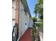 Two story home featuring brick accents, stairs to a deck, exterior door, and security cameras at 4713 9Th E St, Ellenton, FL 34222