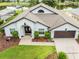 Scenic aerial view of a well-maintained home and beautifully landscaped yard near a tranquil lake at 9246 Dayflower Dr, Tampa, FL 33647