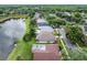 An aerial view highlighting lakeside homes, neighborhood streets and mature landscaping at 9246 Dayflower Dr, Tampa, FL 33647