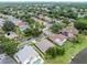 Aerial view featuring a lakeside residential area with mature landscaping, manicured lawns and neighborhood streets at 9246 Dayflower Dr, Tampa, FL 33647