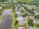 Aerial view of a lakeside residential community, lush landscaping and neighborhood streets at 9246 Dayflower Dr, Tampa, FL 33647