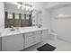Bathroom with double sinks, modern fixtures, and a glass-enclosed shower at 9246 Dayflower Dr, Tampa, FL 33647