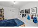 Well-organized bedroom with decoratively adorned wall hooks, adding charm and personality to the space at 9246 Dayflower Dr, Tampa, FL 33647