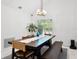 Well-lit dining room with a large dark wood table, bench seating and pendant lighting at 9246 Dayflower Dr, Tampa, FL 33647