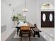 Elegant dining room featuring vaulted ceilings, dark wood furniture, and bright natural light from a large window at 9246 Dayflower Dr, Tampa, FL 33647