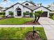 Beautiful single-story home with a lush front yard and a convenient two-car garage at 9246 Dayflower Dr, Tampa, FL 33647