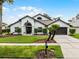 Beautiful single-story home with manicured lawn and elegant landscaping, creating welcoming curb appeal at 9246 Dayflower Dr, Tampa, FL 33647