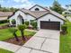 Charming single-story home with a manicured lawn, two-car garage and inviting front yard at 9246 Dayflower Dr, Tampa, FL 33647