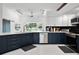 Bright kitchen boasts two-tone cabinets, stainless appliances, and a large window with backyard views at 9246 Dayflower Dr, Tampa, FL 33647