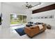 Inviting living room with modern furnishings and a serene backyard view through sliding glass doors at 9246 Dayflower Dr, Tampa, FL 33647