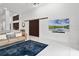 Open living area with modern decor, a wall-mounted TV, and a stylish sliding barn door at 9246 Dayflower Dr, Tampa, FL 33647