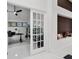 Bright office featuring modern decor, a sleek desk, and a view through paneled glass doors at 9246 Dayflower Dr, Tampa, FL 33647
