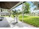 Screened-in patio with tile flooring offers serene views of lush landscaping and a tranquil pond at 9246 Dayflower Dr, Tampa, FL 33647