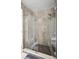 Modern shower features sleek glass enclosure, gray tile, and a rainfall showerhead for a spa-like experience at 9246 Dayflower Dr, Tampa, FL 33647