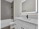 This bathroom features a modern vanity, a backlit mirror, and tiled shower walls at 9573 Migue Cir, Port Charlotte, FL 33981