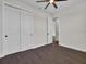 This bedroom boasts wood-look tile and double-door closet at 9573 Migue Cir, Port Charlotte, FL 33981