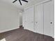 This bedroom boasts wood-look tile and a double-door closet at 9573 Migue Cir, Port Charlotte, FL 33981