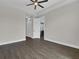 Bedroom with wood-look floors, ceiling fan, walk-in closet and attached bath at 9573 Migue Cir, Port Charlotte, FL 33981