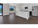 Modern kitchen with a white island, stainless steel appliances, and wood-look flooring at 9573 Migue Cir, Port Charlotte, FL 33981
