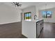 Bright kitchen island with bar seating, an adjacent living room, and a modern chandelier at 9573 Migue Cir, Port Charlotte, FL 33981