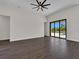 Open living room with sliding glass doors leading to a pool area and a modern ceiling fan at 9573 Migue Cir, Port Charlotte, FL 33981
