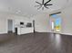 Open-concept living area features white cabinets, an island, and plenty of natural light at 9573 Migue Cir, Port Charlotte, FL 33981