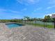Stunning backyard pool with a brick paver patio and a secure black fence at 9573 Migue Cir, Port Charlotte, FL 33981