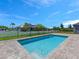Sparkling backyard pool with stone paver deck and secure metal fence at 9573 Migue Cir, Port Charlotte, FL 33981