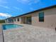 Backyard view of home with private pool and a stylish brick paver patio at 9573 Migue Cir, Port Charlotte, FL 33981