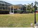 Expansive backyard with a screened in lanai, covered seating, and a well maintained yard at 134 Gulfview Rd, Punta Gorda, FL 33950