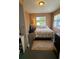 Cozy bedroom featuring a comfortable bed, neutral tones, and a bright window for natural light at 134 Gulfview Rd, Punta Gorda, FL 33950