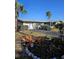 Charming home exterior with well-maintained lawn, mature trees, and attached garage at 134 Gulfview Rd, Punta Gorda, FL 33950
