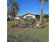 Beautiful home exterior with tropical landscaping, including palm trees and lush plants, enhancing curb appeal at 134 Gulfview Rd, Punta Gorda, FL 33950