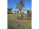 Inviting home exterior with a well-manicured lawn and tropical landscaping, offering a serene view at 134 Gulfview Rd, Punta Gorda, FL 33950