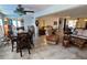 Open-concept living space boasts tile flooring, fan, and an open dining area for easy living at 134 Gulfview Rd, Punta Gorda, FL 33950