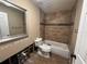 Bathroom featuring a tiled shower and tub combo with a toilet at 1801 Hibiscus S Ct, Oldsmar, FL 34677