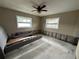 Bedroom with two windows, a ceiling fan, and bare concrete floor at 1801 Hibiscus S Ct, Oldsmar, FL 34677