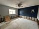 Bedroom featuring concrete flooring, a ceiling fan, a window, and a blue accent wall at 1801 Hibiscus S Ct, Oldsmar, FL 34677