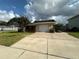 Charming home exterior with a well-maintained front yard and a spacious driveway at 1801 Hibiscus S Ct, Oldsmar, FL 34677