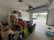 View of the garage featuring a garage door and lots of items at 1801 Hibiscus S Ct, Oldsmar, FL 34677