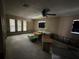 A large, unfinished room with natural lighting and a ceiling fan at 1801 Hibiscus S Ct, Oldsmar, FL 34677